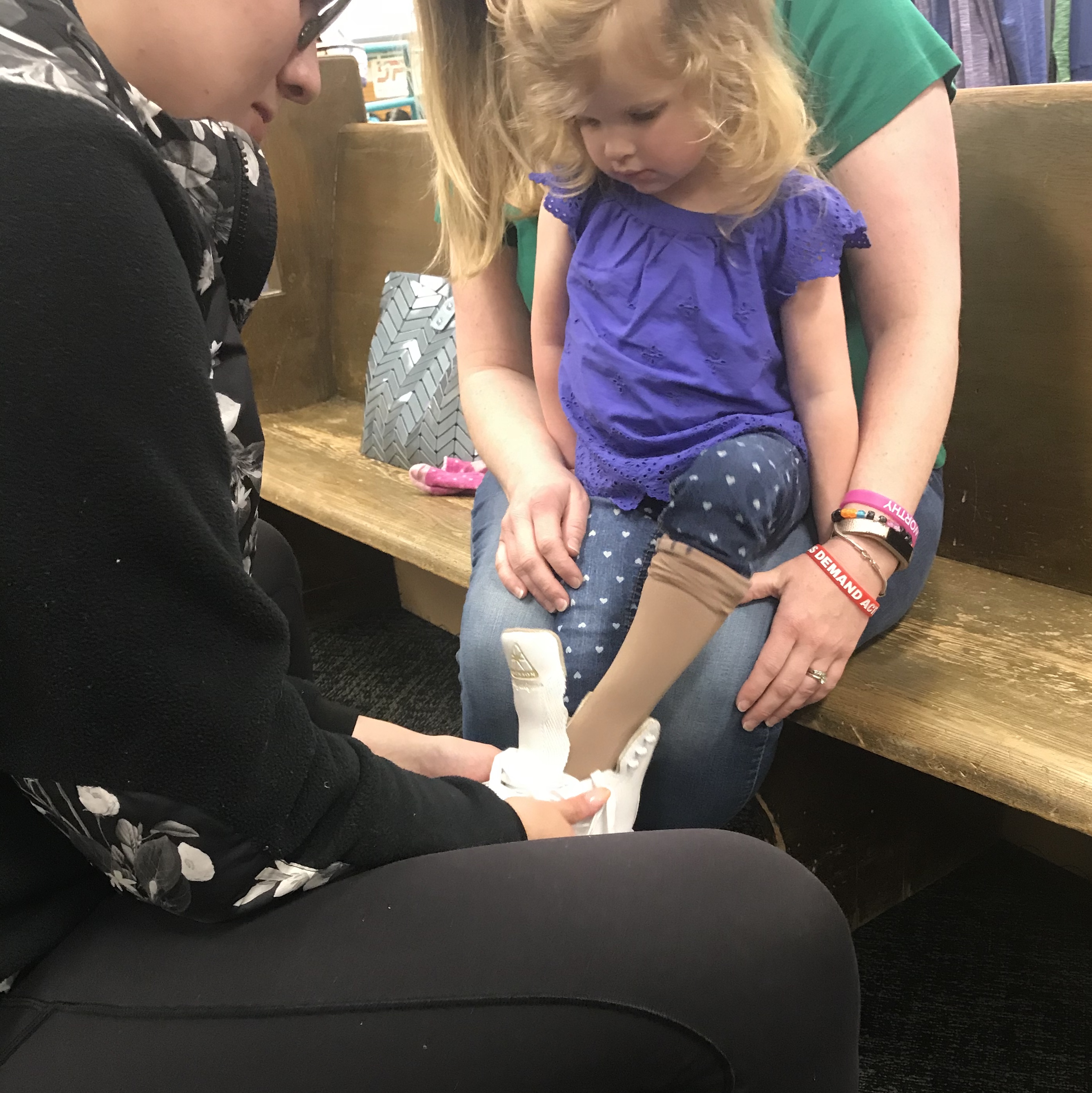 Trying on tiny skates