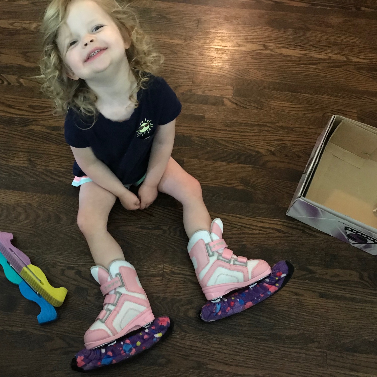 TinyTot is all smiles when she tries on her new skates